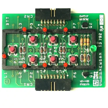 The SM.273 DOSING CIRCUIT is a green board marked “NEWSAN 13792,” featuring red push buttons, black connectors, resistors, LEDs in a grid pattern, and white labels including SM.273. © 2025 1st-line.com