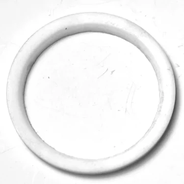 The SM.335 PTFE GASKET 34x27x2 mm, in plain white, rests on a white surface, highlighting its minimalistic and simple design. © 2025 1st-line.com