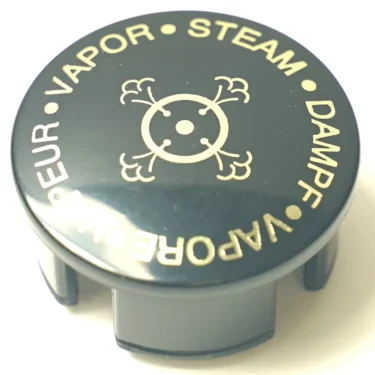The SP.269 STEAM HANDLE LID is a black, circular cap featuring gold text—STEAM, DAMPF, VAPOR, VAPEUR—encircling a central steam cloud or skull-and-crossbones symbol. © 2025 1st-line.com