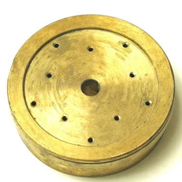 The V.4215 15.2mm diameter black push-button is shown against a white background, featuring a central hole and several smaller holes arranged in a circle on its flat surface. © 2025 1st-line.com