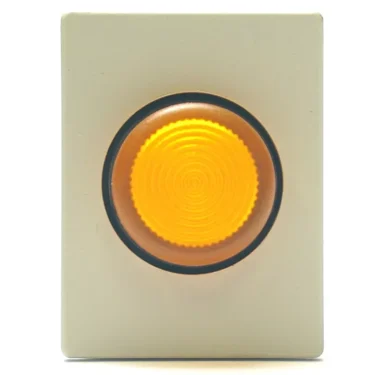 The V.4282 24V LAMP + ORANGE SWITCH features a rectangular light-colored panel with a large, round yellow textured push button in the center, accented by a dark border—designed in the style of an orange switch and 24V lamp. © 2025 1st-line.com
