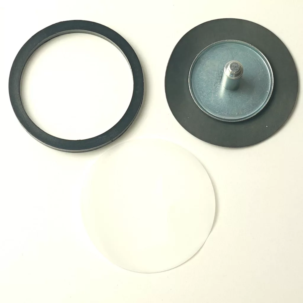 Three circular objects on a white background: a black ring, a metal disc with bolt labeled V..865 3/8 PUMP FILTER, and a clear round sheet, arranged in a rough triangle. © 2025 1st-line.com