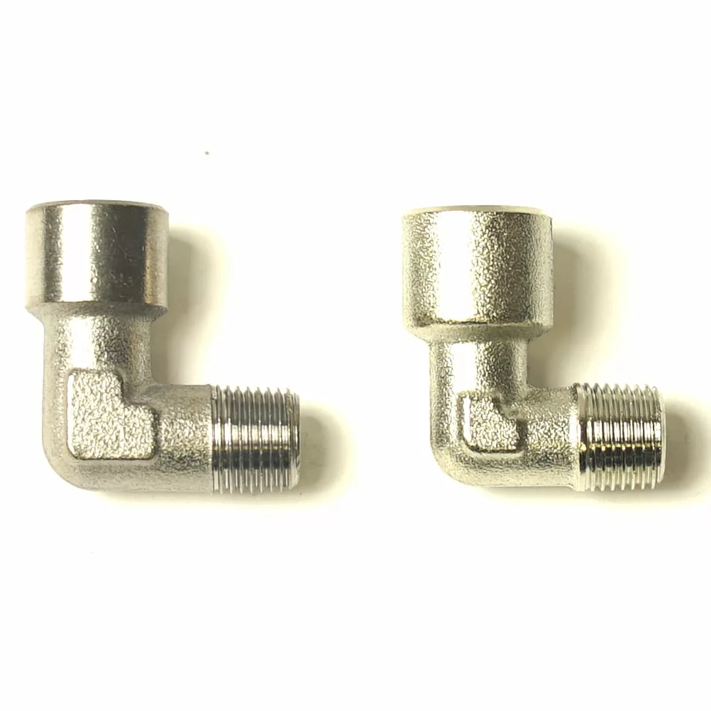 Two metallic 90-degree threaded elbow pipe fittings, ideal for use with the VBM RACCRUBLOLLO Lollo Tap Body, are positioned side by side on a white background. © 2025 1st-line.com