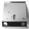 The VBM FRONDOMSMLVRV Front Body Panel is a shiny, metallic panel with circular holes, small engraved symbols, and indented areas, shown on a white background—suitable for electronic or mechanical devices. © 2025 1st-line.com