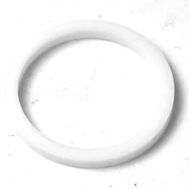 A 1st-line Tap Joint Gasket 20x17x2mm, a plain white circular ring, made of plastic or rubber, is shown on a textured white surface with visible specks. © 2025 1st-line.com