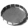 A black and white photo shows a round, metal mesh object with raised edges and a grid pattern, resembling the G...63 SHOWER filter or strainer. © 2025 1st-line.com