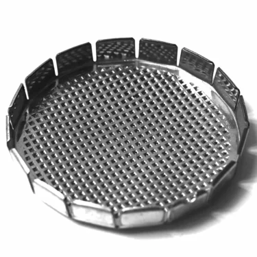 A black and white photo shows a round, metal mesh object with raised edges and a grid pattern, resembling the G...63 SHOWER filter or strainer. © 2025 1st-line.com