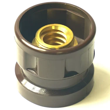 A close-up of a black plastic F..902 E66/P6 STEAM HANDLE plumbing fitting with a threaded brass insert, shown on a white background. © 2025 1st-line.com