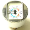 A close-up of a round pressure gauge with a square metal frame shows a 0–4 bar scale with blue, orange, and green segments; an F.2951 ELBOW 1 CUP SPOUT fitting is visible beside the gauge. © 2025 1st-line.com