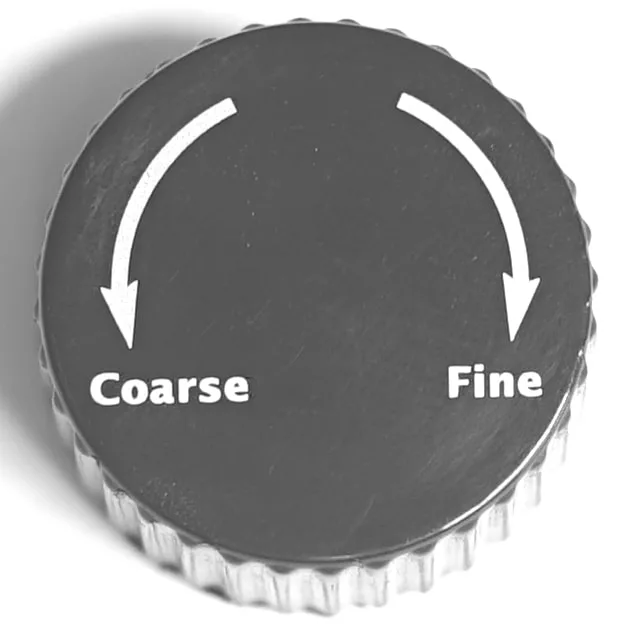 A close-up of the Lelit MC208 Fred Grinder Adjustment Knob shows Coarse on the left and Fine on the right, with curved arrows above each, indicating adjustable grind settings between coarse and fine. © 2025 1st-line.com