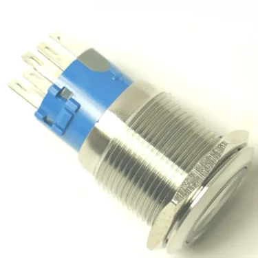 A close-up of the VBM ELETINTDOMOBARNEW POWER SWITCH push button, featuring a metal top, blue plastic base, and multiple silver terminals, displayed on a white background. © 2025 1st-line.com