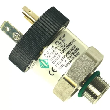 A close-up of the VBM TRASDODE Transducer - 20 bar, featuring a metal threaded connector, black plastic top with three electrical terminals, and a white label showing technical specifications. © 2025 1st-line.com