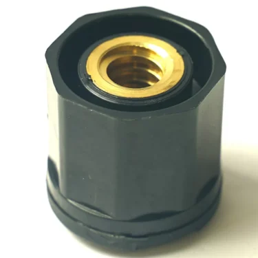 Close-up of a black hexagonal nut with a gold metal insert, designed for the F.1524 STEAM-WATER TAP, shown on a white background. © 2025 1st-line.com