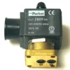 Close-up of a Faema 3-WAY 230V/9W PARKER RUBY solenoid valve coil with visible product labels, 230V specs, and IP65 rating; features brass and black plastic parts—compatible with Faema coffee machines. © 2025 1st-line.com