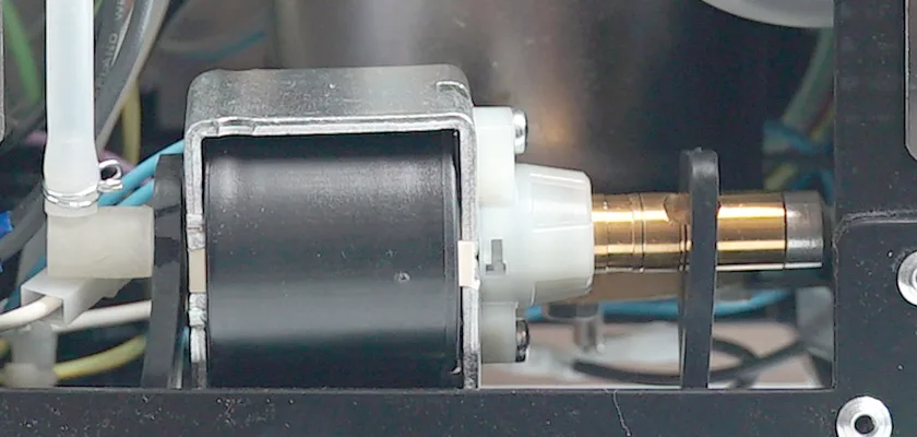 Close-up of a solenoid valve in the Bezzera Crema PM HX Espresso Machine, showing its cylindrical metal coil, brass piston, and multiple electrical wires connected to nearby machine components. © 2025 1st-line.com