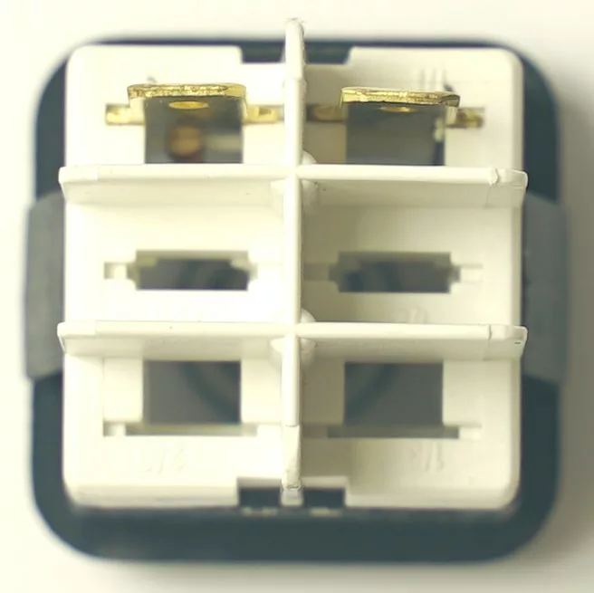 Close-up of a white connector for the LAV144 WARNING LAMP 230V, showing four square slots with gold contacts in two and a black border. LAV144 marking is visible. © 2025 1st-line.com