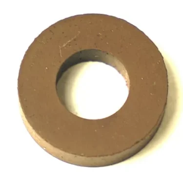 The F..100 LEVEL RUBBER GASKET 21x11.5x5mm is a circular, flat brown gasket with a large central hole, shown from above on a white background. © 2025 1st-line.com