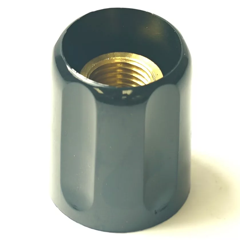 The F.1115 FAEMA COMPACT STEAM AND WATER HANDLE is a black, cylindrical metal cap with a threaded brass interior, designed as a compact steam or water handle—ideal for FAEMA machines. © 2025 1st-line.com