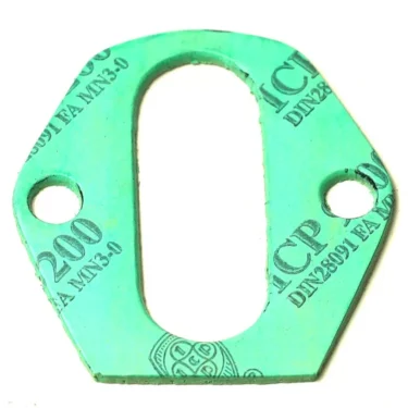 The F.1182 FAEMA/E-61 group to boiler alimentary gasket is green with an elongated oval center cutout, two circular holes on either side, and markings including ICP and 200 printed on its surface. © 2025 1st-line.com
