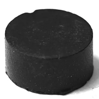 The F..326 CLOSING TAP GASKET 12x5.8 mm is a small, solid black cylindrical tablet with a matte finish, shown against a white background. © 2025 1st-line.com