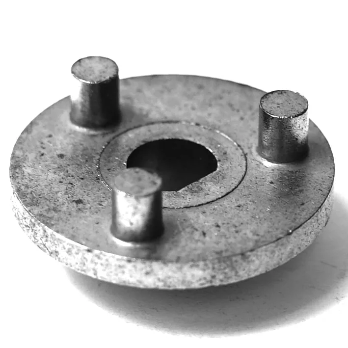 The F..599 PUMP CONNECTING BODY - COUPLER is a round metallic disc featuring a large central hole and three short cylindrical pins on one side in a triangular layout, designed as an ideal pump connecting body. © 2025 1st-line.com