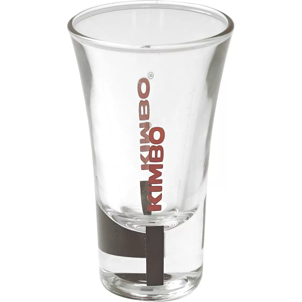 The Kimbo Dublino Shot Glass - 2oz is a clear glass with KIMBO printed vertically in red, featuring a thick base and a gently flared rim. © 2025 1st-line.com