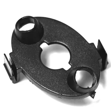 The Lelit 3700027 Switch Bracket is a black, oval plastic part with two round openings and side clips, shown on a white background. It is compatible with Lelit machines. © 2025 1st-line.com