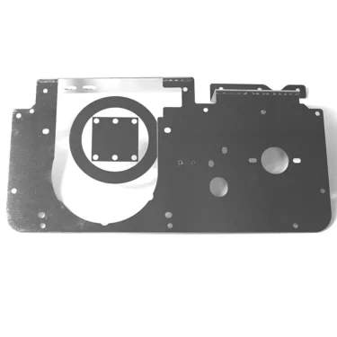 The Lelit MC582 Plaque Base is a flat, black metal platform with a large circle, smaller holes, and a square cutout. Designed for compatibility with the Lelit MC582, it is shown against a white background. © 2025 1st-line.com