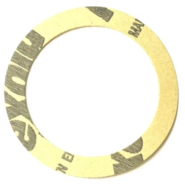 The Ponte Vecchio G8095FL0.4 Flexoid Gasket is a flat, circular, 0.4mm thick gasket with a large central hole and partial black printed text on its brown cardboard surface. © 2025 1st-line.com