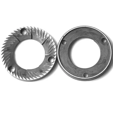 Two MF.506 FLAT GRINDING BURRS 54x31x8 Rh are displayed side by side: the left one has sharp, angled teeth along its inner edge, while the right features a smooth inner circle with three holes. © 2025 1st-line.com