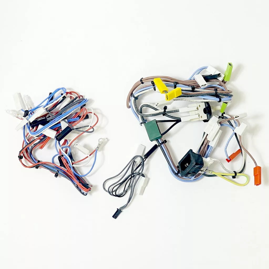 Two tangled bundles of multicolored wires, including a Lelit 3000048 Mara X Wire Assembly, are placed on a white background—one on the left with red, blue, and white wires, and one on the right with varied colors and connectors. © 2025 1st-line.com