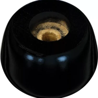 A close-up of a black licorice candy with a beige, chewy center on a white background—its sleek finish reminiscent of the Lelit 4100011 Black Wood Foot. © 2025 1st-line.com