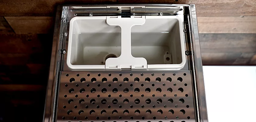 Close-up view of the top of a modern computer case, resembling the perforated metal surface of a Bellezza Inizio R Leva HX Espresso Machine, with an internal white plastic divider. © 2025 1st-line.com