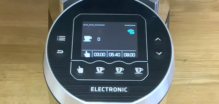 Close-up of a digital coffee machine display with a coffee cup icon, 0, Wi-Fi symbol, and three time options. Below is ELECTRONIC, perfect for pairing with your Mazzer Kony S Time-Based Commercial Espresso Coffee Grinder. © 2025 1st-line.com