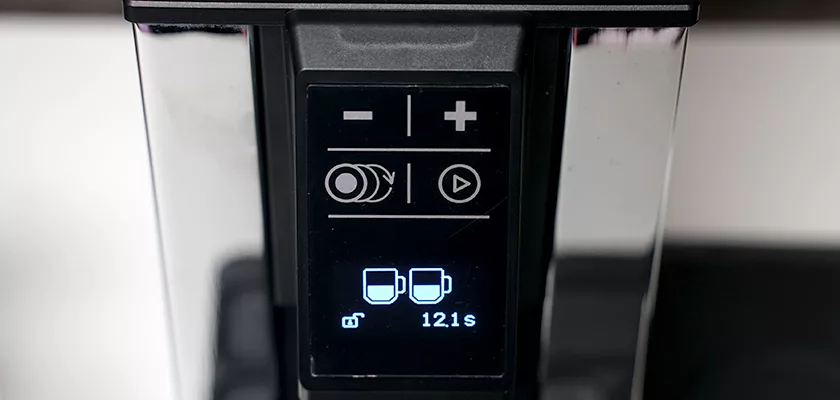 Close-up of a coffee machine digital display with two cup icons and a 12.1-second timer, plus control buttons—an ideal match for your Macap Leo 55 Essential Espresso Coffee Grinder. © 2025 1st-line.com