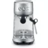 The Breville Bambino™ Espresso Machine in silver, featuring a steam wand, drip tray, control buttons, and portafilter holder, is shown from the front against a white background. © 2025 1st-line.com