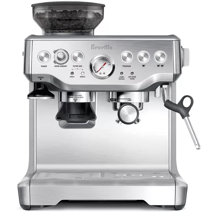 The Breville Barista Express™ Espresso Machine is stainless steel and features a bean hopper on top, control knobs and buttons, a pressure gauge, cup platform, portafilter, and a right-side steam wand. © 2025 1st-line.com