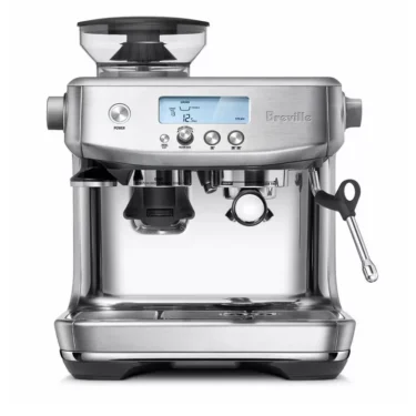The Breville Barista Pro™ Espresso Machine features a stainless steel design, digital display, top grinder, right-side steam wand, portafilter, and front-facing buttons and knobs. © 2025 1st-line.com