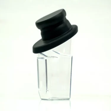 The Fiorenzato 900000996/R Cup (Complete) is a clear glass container with a slanted black lid, featuring an angular, modern design that stands upright against a plain white background—ideal for contemporary spaces. © 2025 1st-line.com