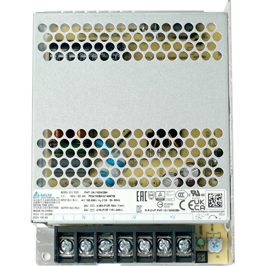 The VBM ELETSWITCHDOM Brain Unit power supply comes in a metal case with a perforated top, labeled terminal screws (L, N, -, V, +), certification symbols, and detailed specs listed on the label beneath the unit. © 2025 1st-line.com