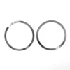 Two thin metallic circular rings from the Fiorenzato 900001434/R Burrs Thickness Kit, each with small notches, are placed side by side on a plain white background. © 2025 1st-line.com