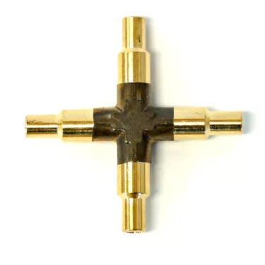 A metallic gold Lelit 2200110 4-Way Cross Fitting with four cylindrical connectors extending from the center, shown on a white background. © 2025 1st-line.com