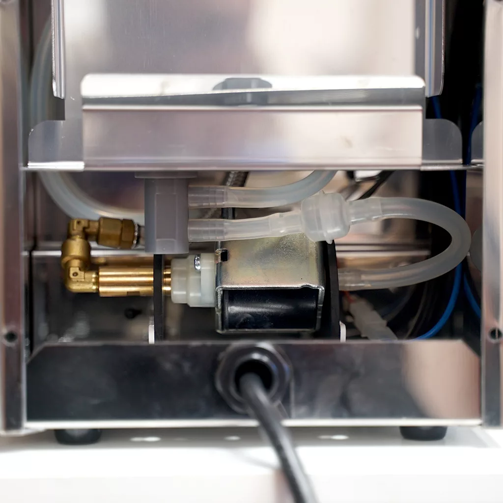 Close-up view of the ECM Casa V interior, showing tubes, wires, and metal fittings—perfect for those interested in accessing the inside of this stainless steel coffee machine. © 2025 1st-line.com