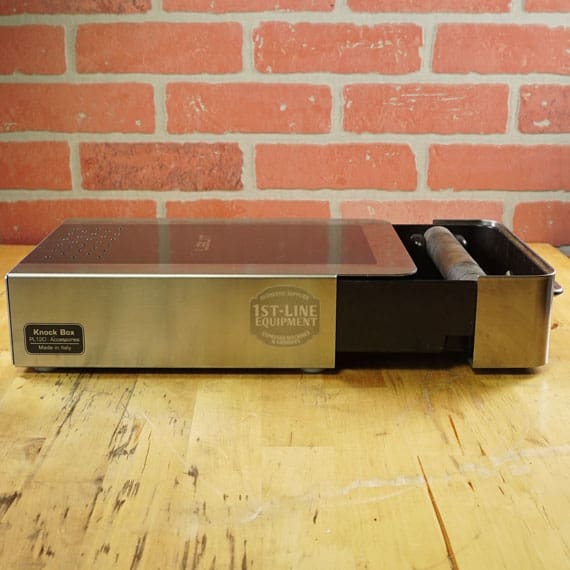 The SIDEWALK SALE - Lelit PLA360M Knock Box Drawer (E208) features a rectangular stainless steel design with a wooden knock bar and sliding drawer—ideal for enhancing your coffee setup or Sidewalk Sale display. © 2025 1st-line.com