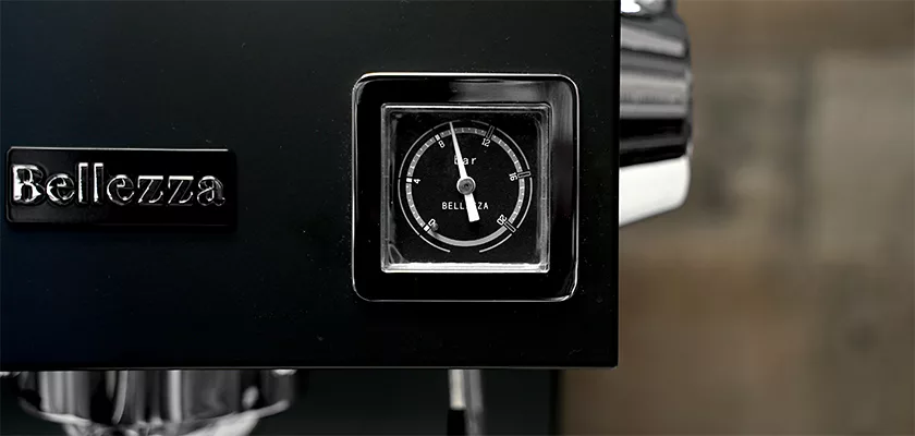 Close-up of the Bellezza Bellona Dual Boiler Espresso Machine, highlighting its pressure gauge and Bellezza logo on a sleek black finish. © 2025 1st-line.com