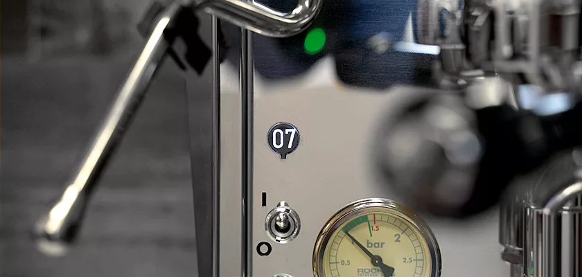 Close-up of the Rocket Giotto Cronometro Type V HX Espresso Machine control panel, showing a digital display reading 07, bar pressure gauge, switch, and a section of its steam wand. © 2025 1st-line.com