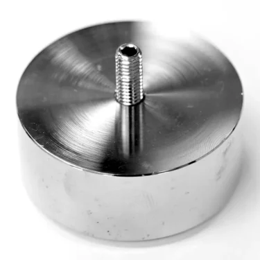 A shiny, cylindrical metal VBM PIEDDOMCR Foot for Domobar Junior Digital HX (NEW STYLE) with a threaded top screw and visible circular machining marks is shown on a white background. © 2025 1st-line.com