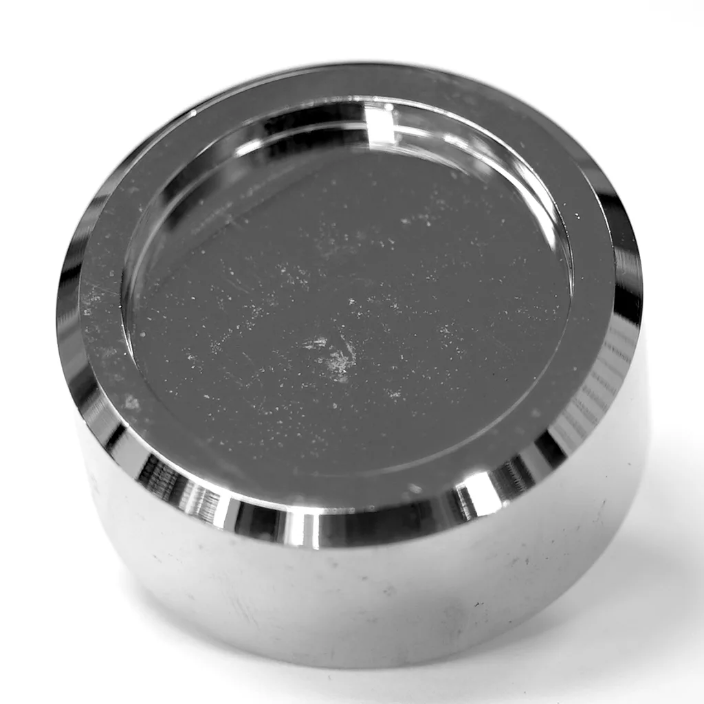 A shiny, round metal puck with a flat, reflective top and smooth edges, shown on a white background—ideal as the VBM PIEDDOMCR Foot for Domobar Junior Digital HX (NEW STYLE). © 2025 1st-line.com
