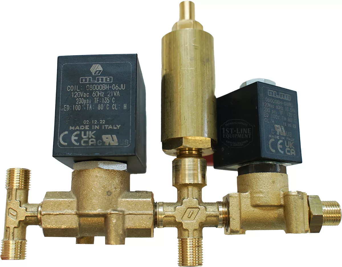 The Lelit 1000166 Solenoid Hydraulic Circuit features two brass solenoid valves with black electronic coils connected by a cylindrical brass part, all displaying technical labels and certification marks on the coils. © 2025 1st-line.com