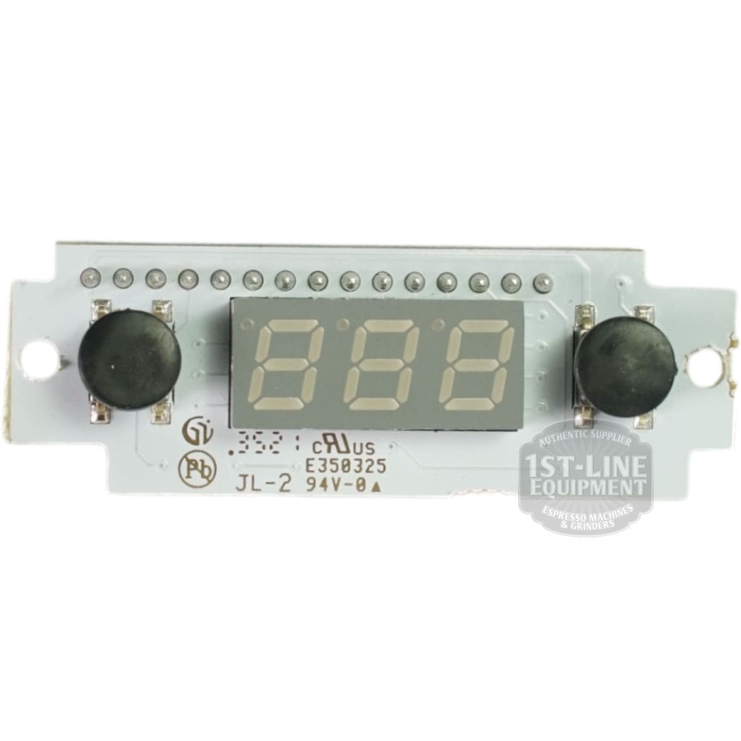 The Bezzera 5968144 White PID Kit 110V features a digital display module with a three-digit LED screen, two black round buttons on each side, and is mounted on a PCB with electronic components and printed certification marks. © 2025 1st-line.com